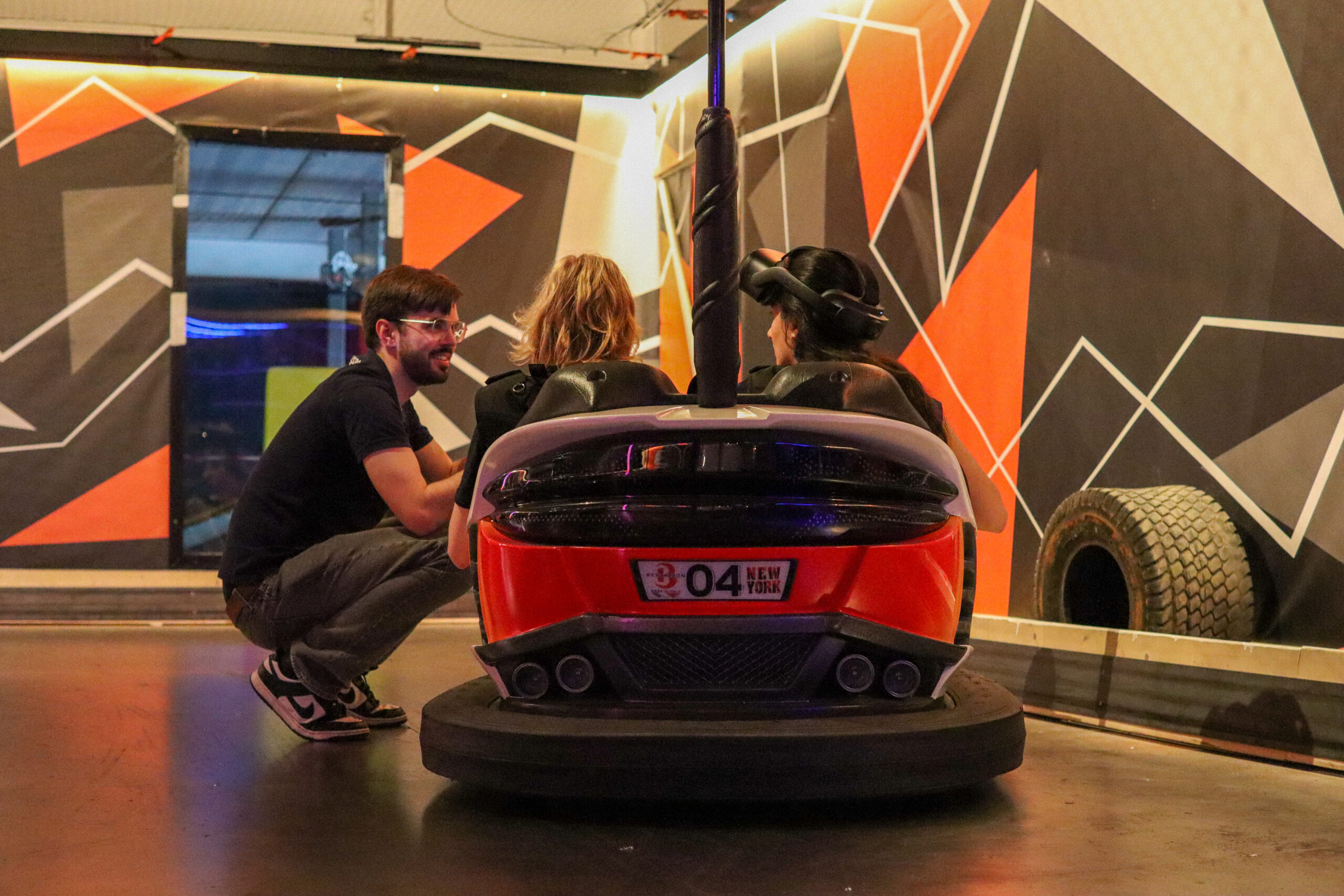 An Easysee dev attending to two participants in their VR bumper car